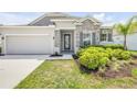 Attractive single-Gathering home featuring stone detailing, two-car garage and beautifully landscaped front yard at 1012 Bradford Ridge Dr, Leesburg, FL 34748