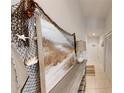 Inviting hallway with tile flooring, decorative nautical artwork, and a wooden accent table at 106 Tuscany Villas Dr # 0160, Edgewater, FL 32141