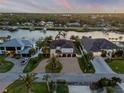 Aerial view of waterfront homes on a river with docks and boats, surrounded by palm trees at 1212 Commodore Dr, New Smyrna Beach, FL 32168