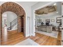 Elegant entryway with hardwood floors, a brick archway, and a view into the office at 1212 Commodore Dr, New Smyrna Beach, FL 32168