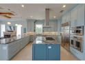 Spacious kitchen featuring a large island, stainless steel appliances, and custom cabinets for ample storage space at 1221 Commodore Dr, New Smyrna Beach, FL 32168