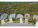 Wide aerial view showcasing home's neighborhood and adjacent wooded area with walking bridge at 1363 Wayne Ave, New Smyrna Beach, FL 32168