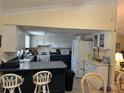 Kitchen featuring white cabinets and a breakfast bar, creating a functional cooking space at 1629 Travelers Palm Dr, Edgewater, FL 32132