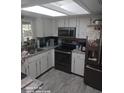 Bright kitchen with white cabinets, stainless steel appliances, and a window above the sink at 168 N Cory Dr, Edgewater, FL 32141