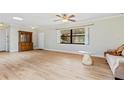 Open living space featuring wood floors, a hutch, and ample natural light at 1855 Pine Tree Dr, Edgewater, FL 32141