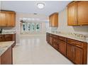 Bright kitchen featuring granite countertops, modern cabinetry, and a view of the open-concept living room at 1868 Pine Tree Dr, Edgewater, FL 32141