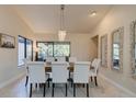 Dining room featuring a modern chandelier, large windows and stylish mirrors that add charm and elegance at 1918 Whisperwood Way # 10, Port Orange, FL 32128