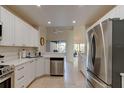Bright kitchen with white cabinets, stainless steel appliances, and an open layout for easy entertaining at 1918 Whisperwood Way # 10, Port Orange, FL 32128