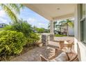 Inviting front porch with comfortable seating surrounded by lush landscaping at 220 Venetian Palms Blvd, New Smyrna Beach, FL 32168