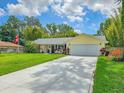 Charming home with well manicured lawn, two-car garage, and long concrete driveway at 2236 Davis Dr, New Smyrna Beach, FL 32168