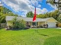 Charming single-story home with a well-manicured lawn and colorful landscaping at 2236 Davis Dr, New Smyrna Beach, FL 32168