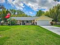 Charming home with well manicured lawn, two-car garage, and beautiful landscaping at 2236 Davis Dr, New Smyrna Beach, FL 32168