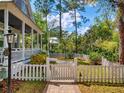 Charming home with a white picket fence, brick walkway, and lush landscaping at 2656 Old Smyrna Trl, New Smyrna Beach, FL 32168
