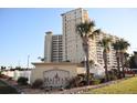 View of Halifax Landing community with its beautifully landscaped grounds, building facade, and signage at 2801 S Ridgewood Ave # 512, South Daytona, FL 32119
