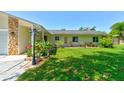 Beautiful home with stone accents, manicured lawn, and charming curb appeal at 2914 Sabal Palm Dr, Edgewater, FL 32141