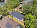 Aerial view of property with yellow outline surrounded by mature trees and neighboring properties at 3349 Glenshane Way, Ormond Beach, FL 32174