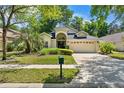 Charming single-story home featuring a well-maintained lawn, mature landscaping and a two-car garage at 3349 Glenshane Way, Ormond Beach, FL 32174