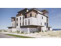 Well-maintained three-story condo featuring a balcony, modern finishes, an attached garage and a front entrance at 3403 S Atlantic Ave # 3, New Smyrna Beach, FL 32169