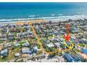 Aerial view shows the proximity of the home to the beach in a desirable neighborhood at 4009 S Peninsula Dr, Wilbur By The Sea, FL 32127