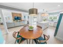Open-concept living space with modern kitchen, dining area, and comfortable seating area at 4009 S Peninsula Dr, Wilbur By The Sea, FL 32127