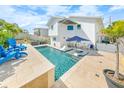 This private backyard oasis features a pool, stylish furniture, and lush landscaping at 4009 S Peninsula Dr, Wilbur By The Sea, FL 32127