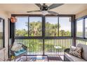 Relaxing screened balcony with ceiling fan and comfortable seating with beautiful outdoor view at 402 Bouchelle Dr # 206, New Smyrna Beach, FL 32169