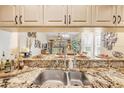 Stylish kitchen featuring granite countertops and a view to the cozy living area at 402 Bouchelle Dr # 206, New Smyrna Beach, FL 32169
