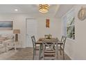 Bright dining area featuring neutral walls, wood-look flooring, and a stylish light fixture at 4307 Sea Mist Dr # 135, New Smyrna Beach, FL 32169