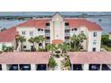 Beautiful waterfront condominium with red tile roof and lush palm trees at 438 Bouchelle Dr # 104, New Smyrna Beach, FL 32169