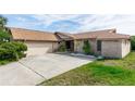 Inviting single-Gathering home featuring a brick exterior, attached garage, mature landscaping, and large driveway at 4431 Doris Dr, New Smyrna Beach, FL 32169