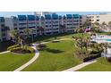 Beautiful building with a manicured lawn, palm trees and direct access to the pool at 4501 S Atlantic Ave # 5060, New Smyrna Beach, FL 32169