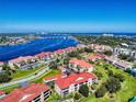 Expansive aerial view showcasing this condo community with waterway and stunning blue sky at 468 Bouchelle Dr # 128, New Smyrna Beach, FL 32169