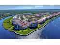 Stunning aerial view of a waterfront condominium complex on a sunny day, with manicured lawns at 468 Bouchelle Dr # 128, New Smyrna Beach, FL 32169
