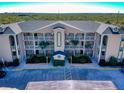 The condo building features well-maintained landscaping, neutral paint, and a manicured entrance at 468 Bouchelle Dr # 128, New Smyrna Beach, FL 32169