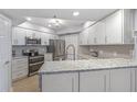 Well-lit kitchen featuring stainless steel appliances, modern cabinets, and granite countertops at 5300 S Atlantic Ave # 14-202, New Smyrna Beach, FL 32169