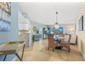 Open concept living room and kitchen area with tile floors and modern furnishings at 5300 S Atlantic Ave # 14-202, New Smyrna Beach, FL 32169