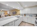 Open kitchen design with a breakfast bar overlooks the living area, enhancing the spacious feel at 5300 S Atlantic Ave # 16-205, New Smyrna Beach, FL 32169