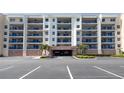 Condo building featuring large balconies with parking garage and landscaped entryway for a welcoming feel at 5300 S Atlantic Ave # 20-507, New Smyrna Beach, FL 32169