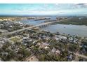 Birds-eye view of the home near the water, bridges, and city of New Smyrna Beach at 600 Magnolia St, New Smyrna Beach, FL 32168