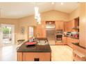 Bright kitchen featuring custom cabinets, stainless steel appliances, tile flooring, and a kitchen island with a sink at 6093 Sabal Creek Blvd, Port Orange, FL 32128