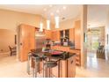 Modern kitchen featuring custom cabinetry, granite countertops, a large center island with seating, and stainless steel appliances at 6093 Sabal Creek Blvd, Port Orange, FL 32128
