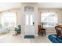 Bright foyer with a large front door, neutral walls, and plenty of natural light from the windows at 6403 Adrianne Ct, Port Orange, FL 32128