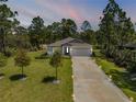 Attractive single-story home with a long driveway, well-maintained lawn, and surrounded by mature trees for added privacy at 703 Volco Rd, Edgewater, FL 32141