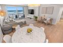 Open-concept living area with a marble table, comfy seating, and stunning ocean views at 705 N Atlantic Ave # 4030, New Smyrna Beach, FL 32169