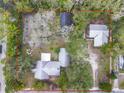 Overhead view of a large parcel showing home, garage, and storage building within mature trees and lot boundary at 801 Canal St, New Smyrna Beach, FL 32168