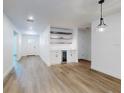 Bright living room with hardwood floors, custom shelving, mini fridge, recessed lighting, and open floor plan at 808 Rosalia Dr, Sanford, FL 32771
