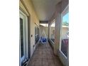 Covered entryway with tiled flooring, seating, and partial view of the home's exterior at 2530 Tamarind Dr, Edgewater, FL 32141
