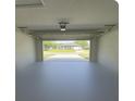 Spacious garage with an open door showcasing the home's curb appeal at 2530 Tamarind Dr, Edgewater, FL 32141