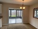 Dining room boasts sliding glass doors that lead to a screened patio at 3048 Unity Tree Dr, Edgewater, FL 32141