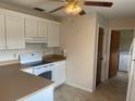 A well-lit kitchen showcases a white range and bright cabinetry at 3048 Unity Tree Dr, Edgewater, FL 32141